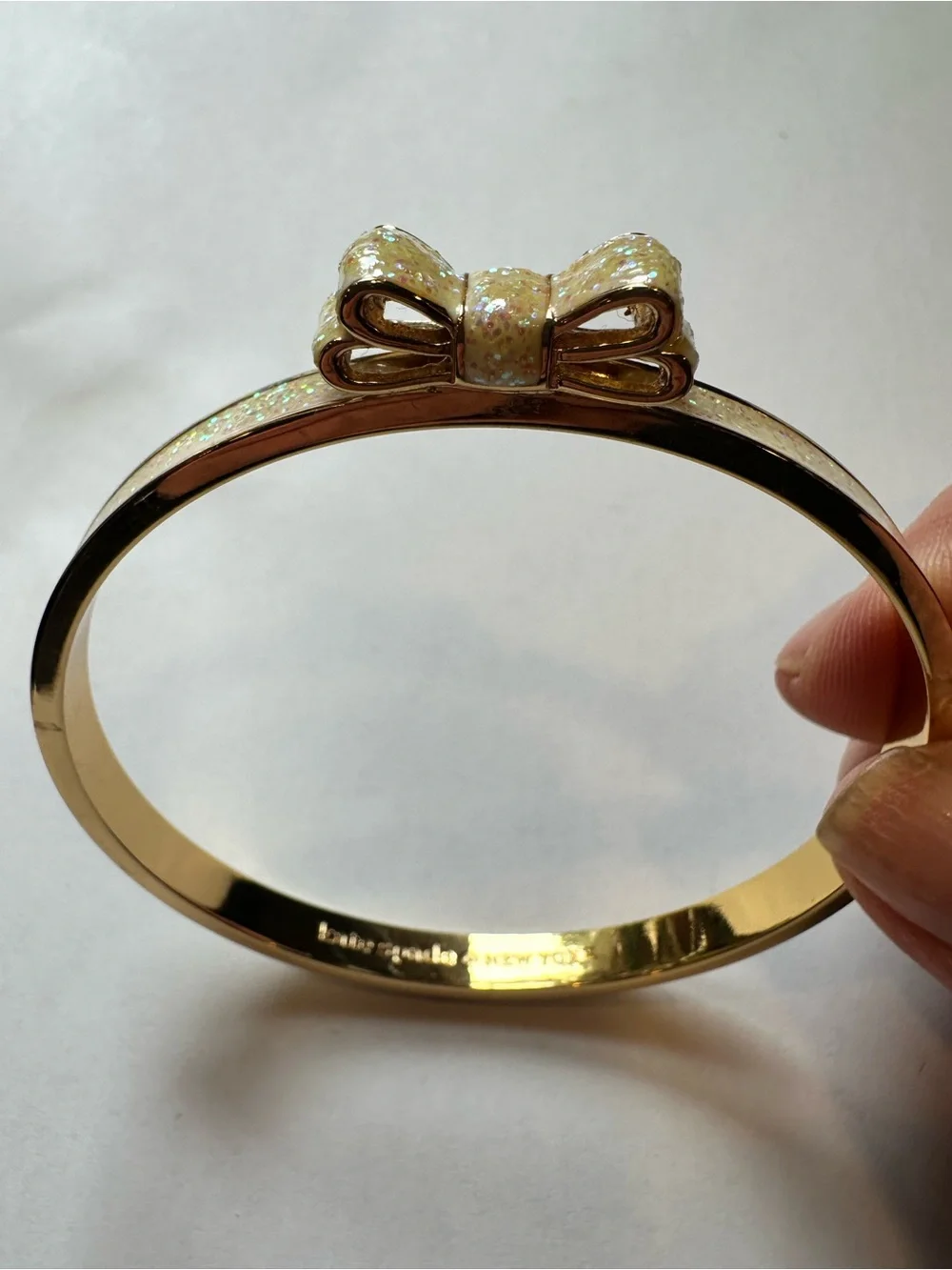 Kate Spade Gold Bow Bangle Bracelet with Iridescent Cream Inlay
